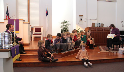 Children gather to sit on the church chancel platform and listen to the special message for children during worship service at Warrenton Presbyterian Church.
