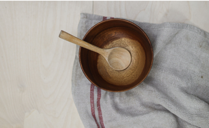 Empty bowl and spoon with gray homespun linen towel